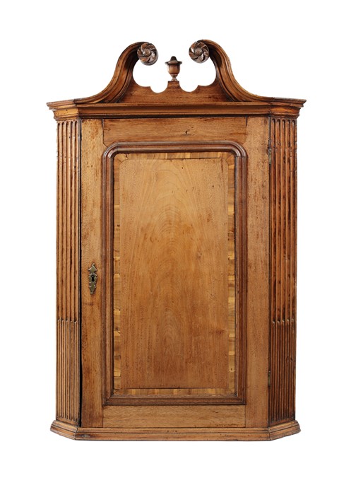 A George II walnut and crossbanded hanging corner cupboard