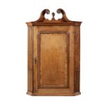 A George II walnut and crossbanded hanging corner cupboard