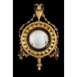 A small Regency carved gilt wood convex girandole