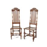 A pair of Queen Anne carved oak high back side chairs, circa 1710