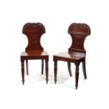 A pair of Regency mahogany hall chairs