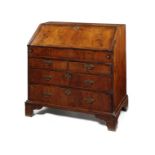A Queen Anne walnut crossbanded and featherbanded bureau
