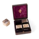 A pretty set of four Victorian square two-colour parcel-gilt silver-plated napkin rings, circa 1880