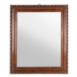 A Victorian carved oak rectangular frame with mirror plate