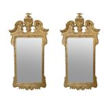 A pair of George II style carved giltwood and cut gesso mirrors