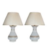 Two pairs of white and gilt table lamps