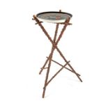 A French floral patterned circular white porcelain plate on a rustic tripod stand