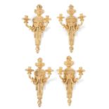 A set of four Louis XVI style gilt wood twin-sconce wall lights