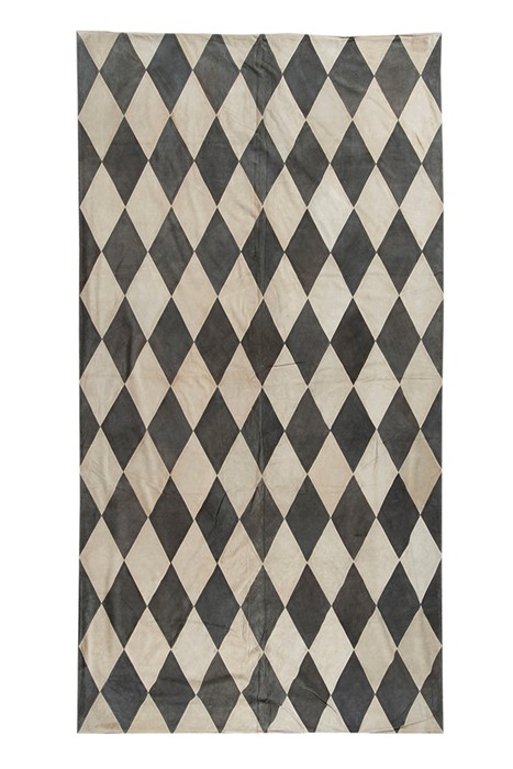 A contemporary diamond motif suede rug