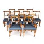 A set of twelve Victorian Gothic Revival carved oak dining chairs incl. a pair of open armchairs