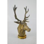 A car mascot in the form of a stag, silvered brass, 14cm high.