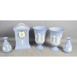 A group of Wedgwood Jasperware including a clock 22cm high, a pair of urns and a pair of vases
