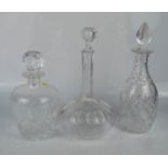 Three cut glass decanters of various form.