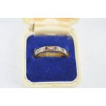 A 9ct gold band set with diamonds and sapphires, size P, 2.6g.