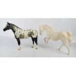 Two Beswick horses; one dappled and one white example, 20cm high.