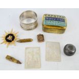 A group of collectables to include gilt metal brooch, silver napkin ring, mother of pearl tokens,