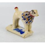 An 18th century whistle, in the form of a dog, tin glazed, possibly French faience, 7cm high.