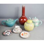 A group of Chinese pottery to include teapot, ginger jar, and vase.