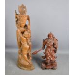Two carved wooden figures, a Japanese Samurai Warrior 30cm high and an Indonesian deity 51cm high.