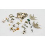 A quantity of costume and silver jewellery including a brooch in the form of a bird, earrings,