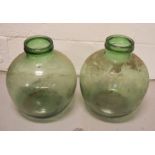 A pair of green glass terrariums.