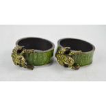 A pair of green enamel napkin rings modelled with frogs.