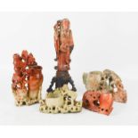 A group of Chinese soapstone carvings, including brush pots, figure and one with lotus flowers.