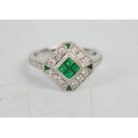 An 18ct white gold, emerald and diamond Art Deco style ring, with four brilliant cut emeralds,