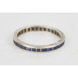 A white metal and paste ring, set with square cut blue stones, S½, 2.2g