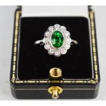 An 18ct white gold and Tsavorite garnet and diamond ring, of flowerhead form, with approx 1ct