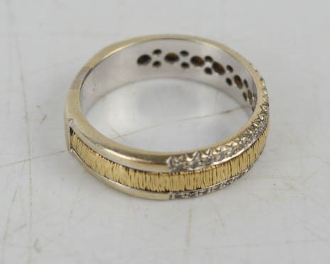 A 9ct white and yellow gold band ring set with thirty four diamonds, (unmarked), 5.6g. - Image 2 of 2