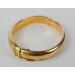 A gold bracelet (untested) with safety chain, and chased decoration, 16.69g.