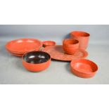 A red lacquer oval dish together with bowl, jars and dishes.