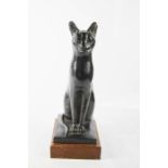 A plasterwork bronzed patinated sphynx raised on a plinth 31cm high.