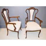 A pair of Edwardian armchairs, shaped and carved backs, upholstered in Nina Campbell designed