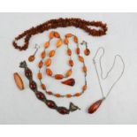 A group of amber necklaces, one with rough cut beads, one of cloudy graduated beads, a pair of