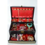 A jewellery box containing various jewellery to include necklaces, rings and bracelets.