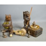 A group of Blackforest examples including a stand in the form of bear, two bottle stoppers and a