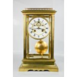 A 19th century brass mantle clock, with porcelain Roman Numeral dial, 43 by 25 by 43cm.