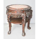 A Chinese Imperial jardiniere stand, with inset marble top and five legs, carved with symbols.