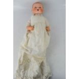 An Armand Marseille bisque head doll, numbered to the back of the head 351/2k, circa 1920, wearing a