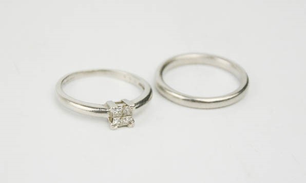 A platinum and diamond ring, marked 950, set with four brilliant cut diamonds, 4.6g, together with a