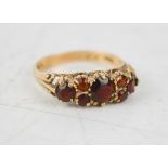 An 18ct gold and garnet ring, in a Victorian setting.