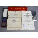 WWII SS service award medals and corresponding paperwork and 1936 Spanish Civil war armband.