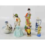 A group of figurines, including two Chinese examples.