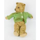 A 19th century teddy bear with green knitted jumper. 40cm high.