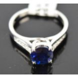 An 18ct white gold, blue sapphire and diamond ring, 1.8ct sapphire, with diamond set shoulders, size