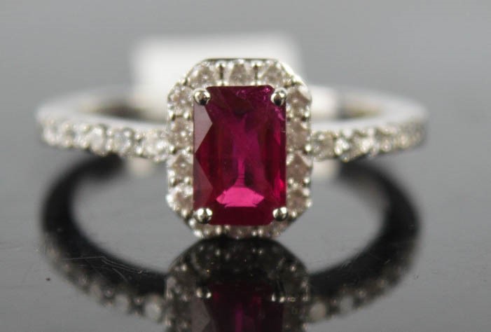 An 18ct white gold, ruby, and diamond ring, the ruby approx 1ct, surrounded by diamonds approx 0.4ct