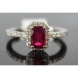 An 18ct white gold, ruby, and diamond ring, the ruby approx 1ct, surrounded by diamonds approx 0.4ct