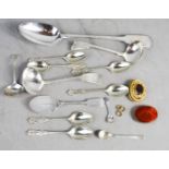 A quantity of silver plated cutlery and three brooches.